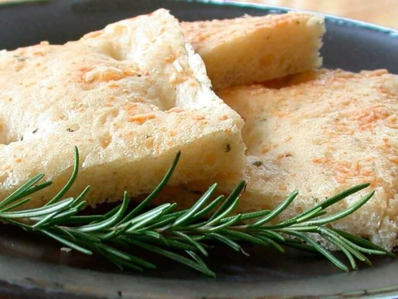 Original ligurische Focaccia mit Olivenöl und mediterranen Kräutern als Spezialität der ligurischen Küche